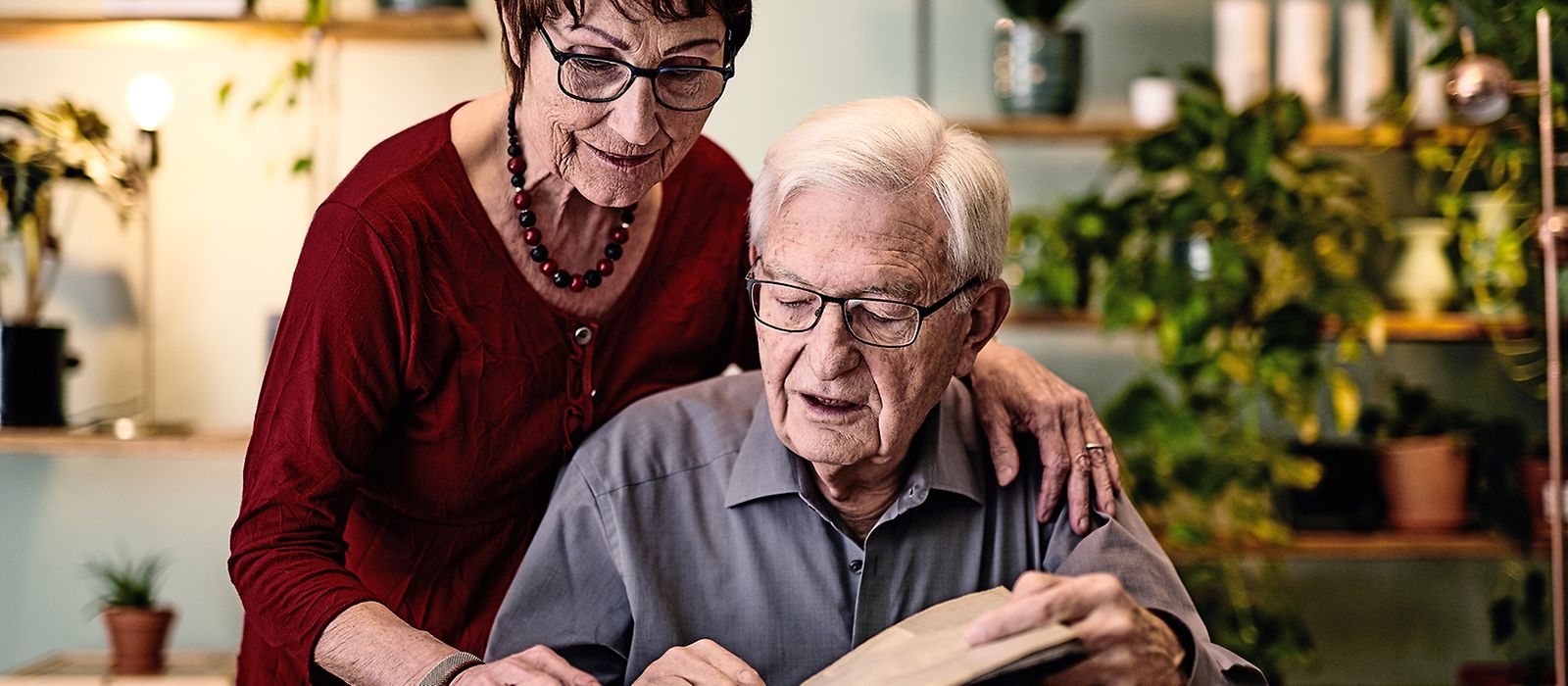 Älteres Paar schaut sich ein Fotoalbum an.