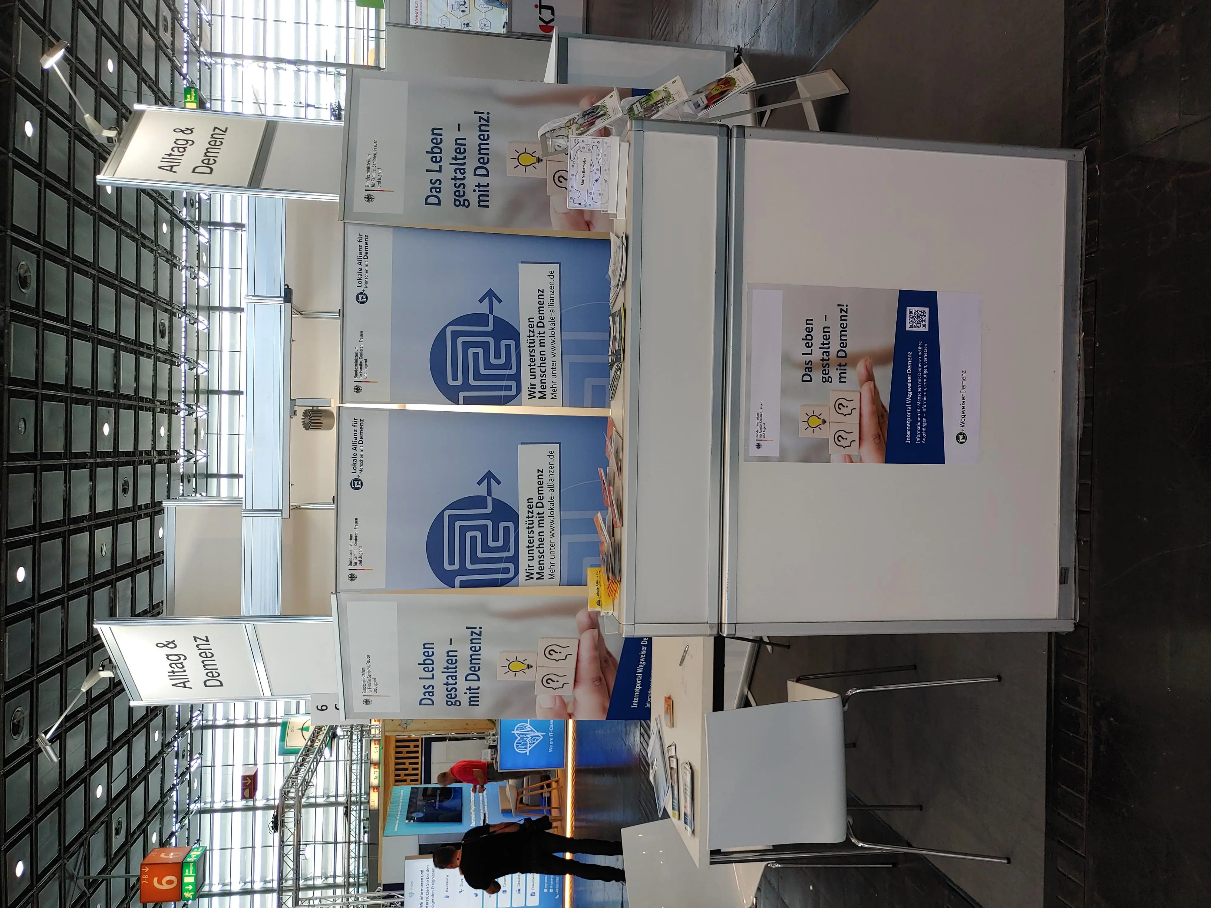 Ausstellerstand versehen mit Plakaten und Roll-Ups sowie Flyern.