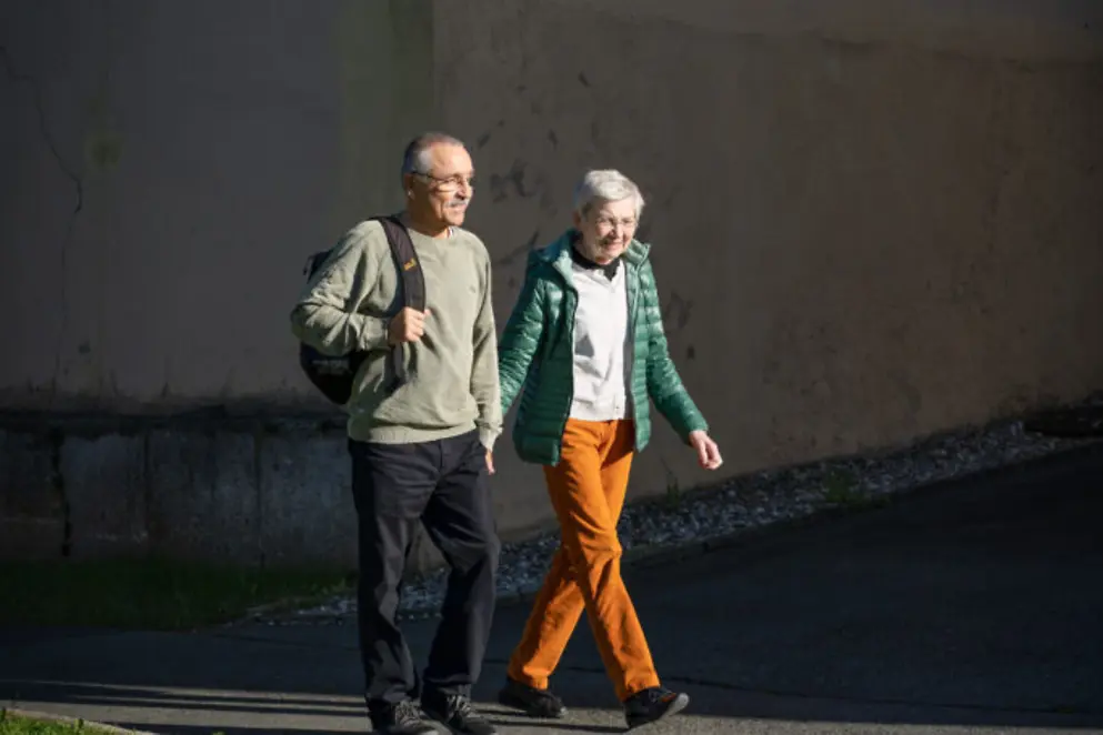 Zwei Personen spazieren draußen.